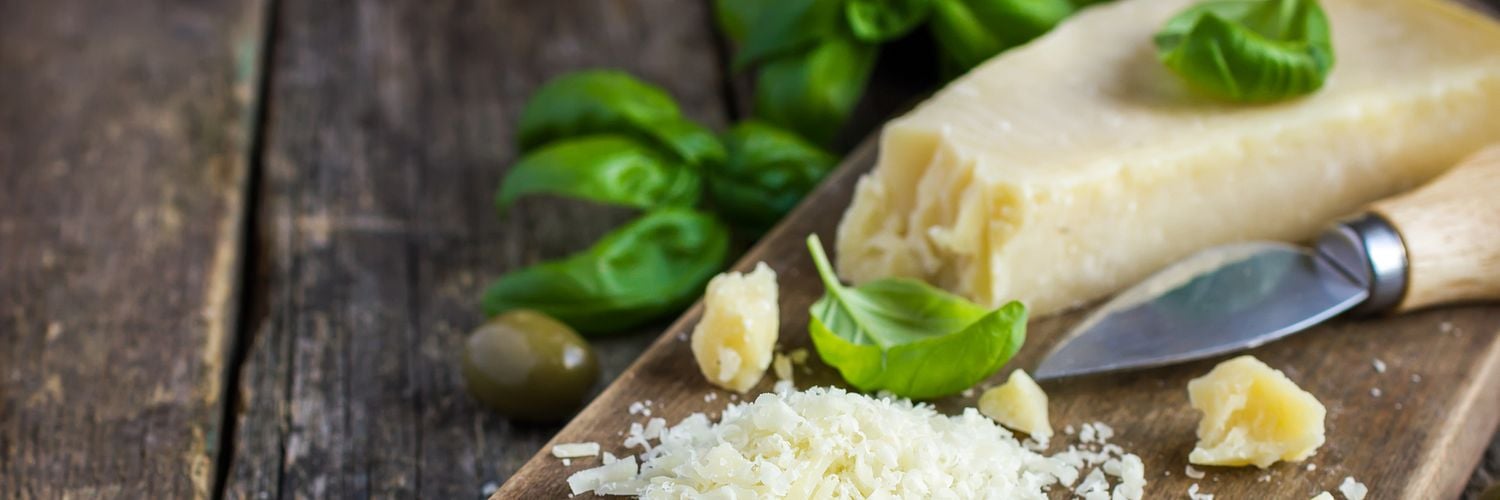 parmesan cheese on wooden cutting board